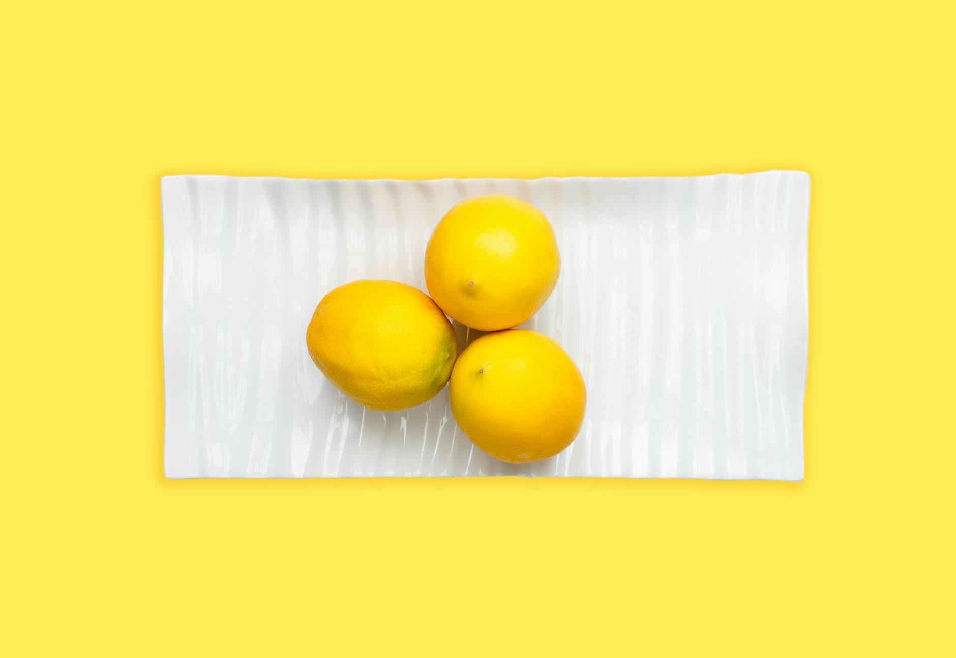 Fresh lemons on white plate symbolizing renewed sensation and pleasure after stopping hormonal birth control