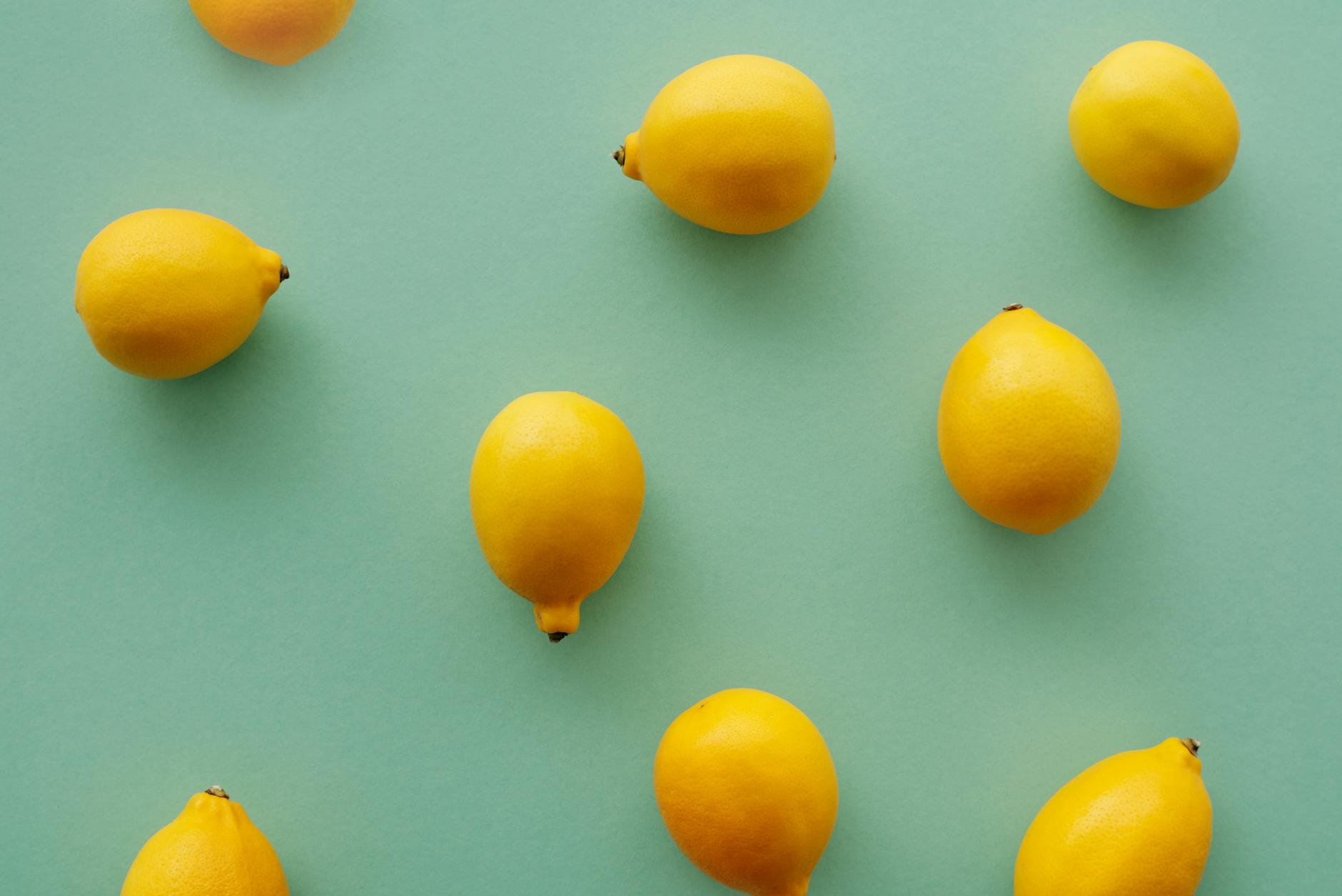 Bright yellow lemons arranged on a soft pastel background, symbolizing the refreshing approach to pleasure in age-gap relationships